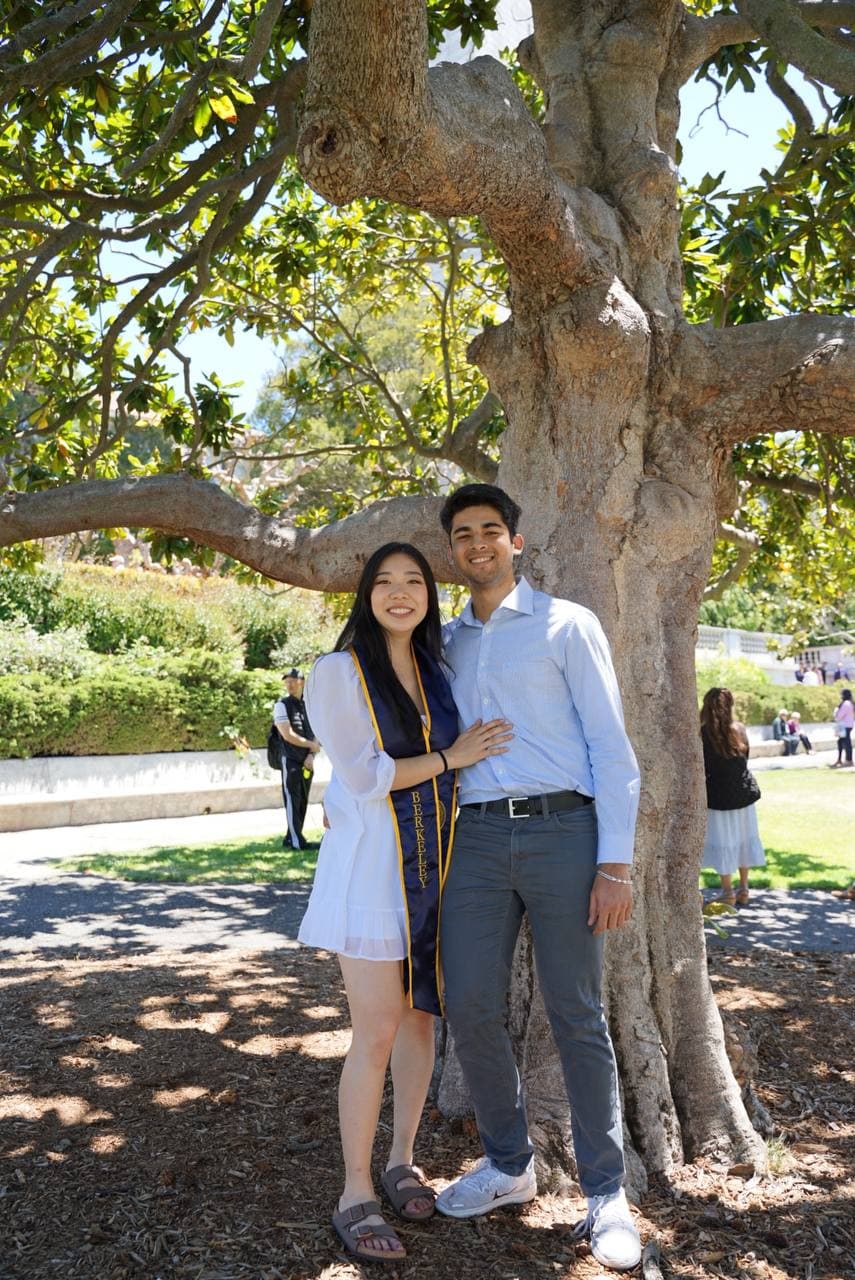Amy in her Berkeley stole under a magnolia tree, with Roshan