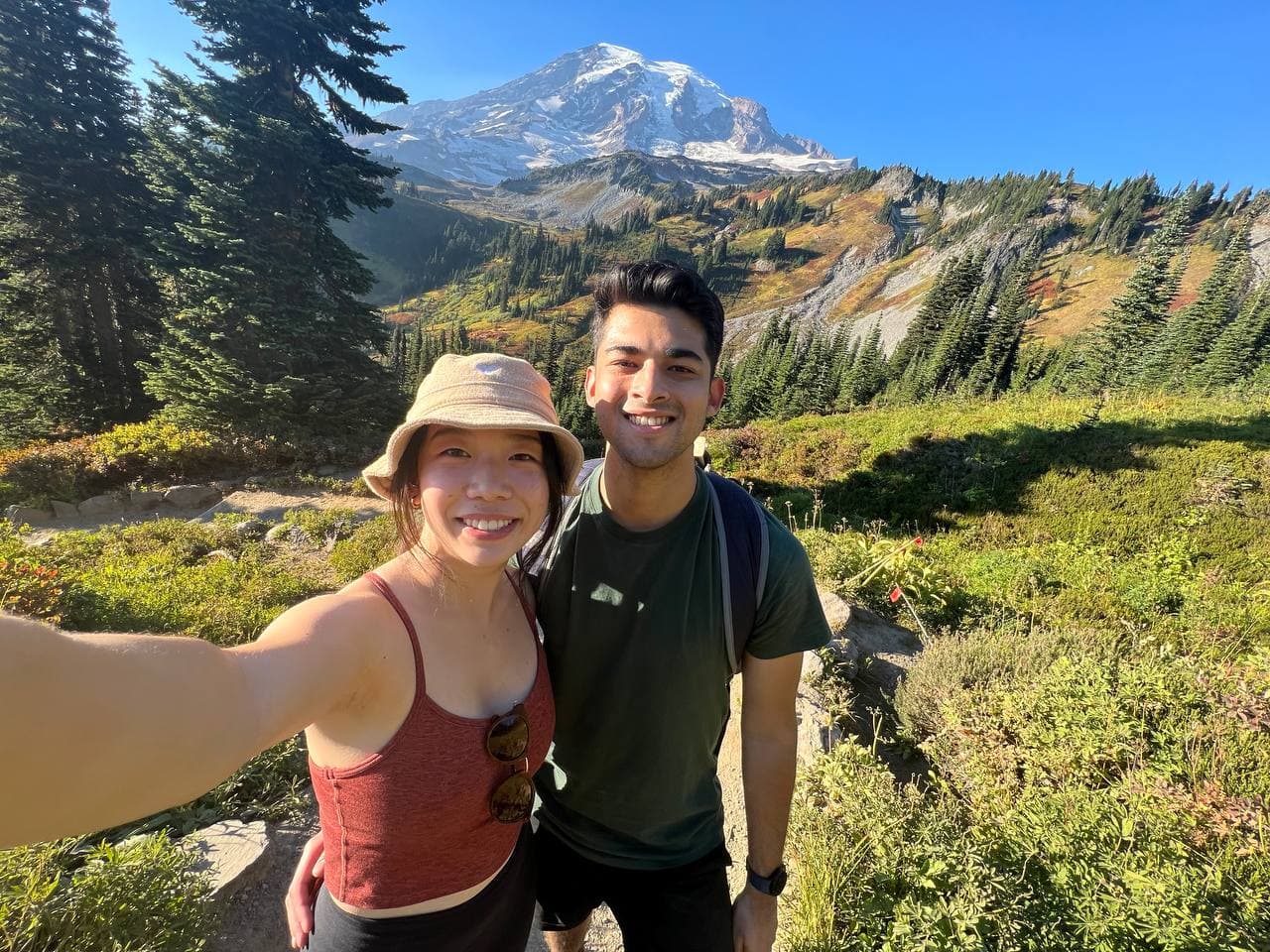Amy and Roshan on a hike with Mt. Rainier behind them
