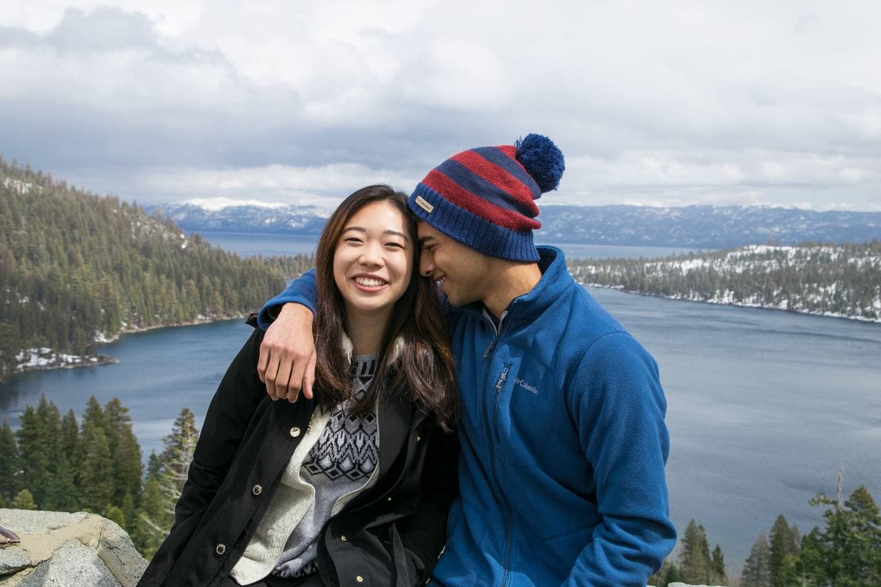 Amy and Roshan overlooking Lake Tahoe on a snowy day